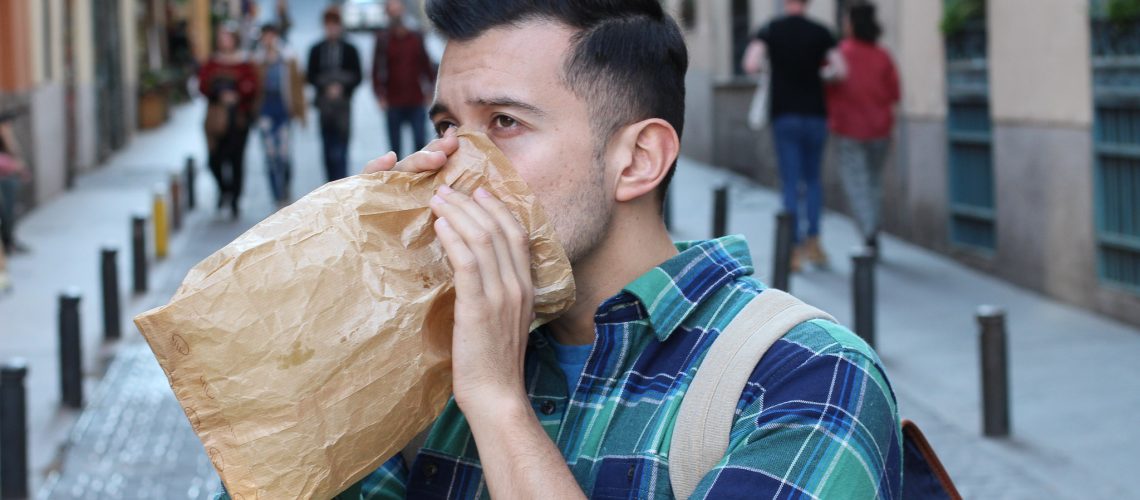 Man having a panic attack in the crowd