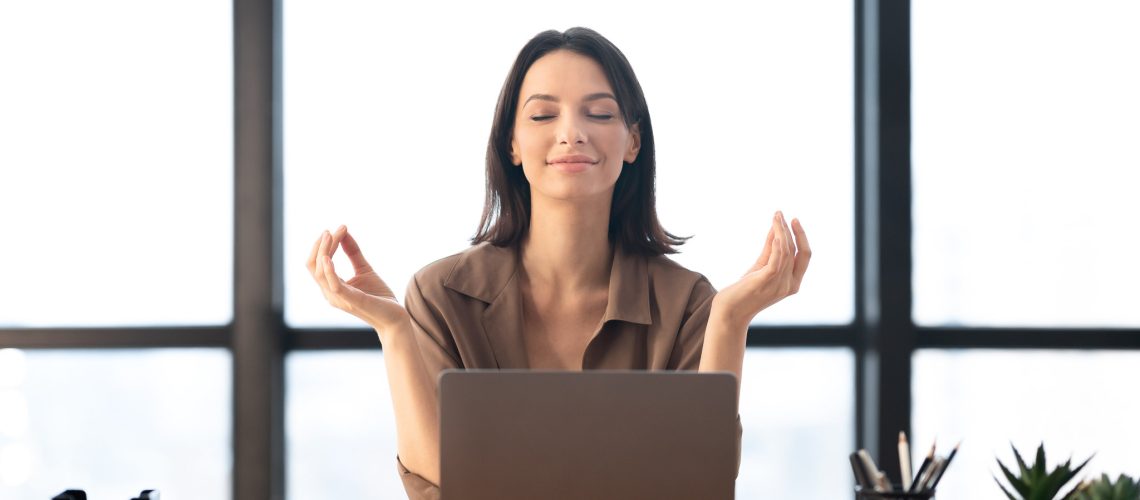 Relaxation At Work. Calm businesswoman meditating at work, dealing with stress and anxiety. Free space