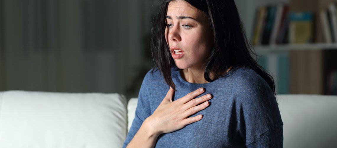 Woman suffering an anxiety attack alone in the night