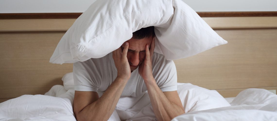 Sleep Disorders and Problems. Man struggling with insomnia.