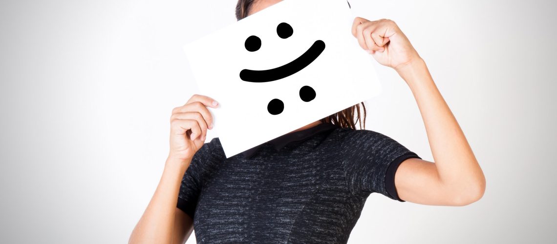 Young woman facing bipolar disorder - happy and sad two-faced expression