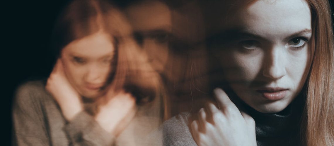 Angry teenage girl holding her hand close to her face