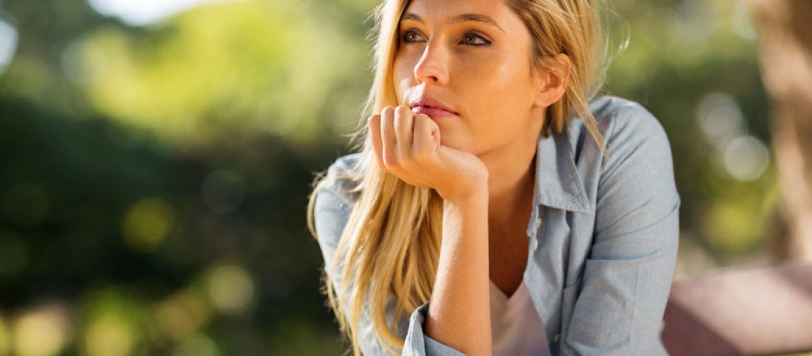 41330505 - thoughtful woman sitting alone outdoors