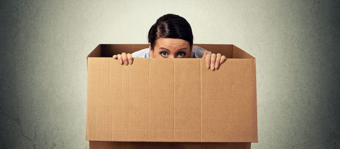 43705172 - young woman hiding in a carton box